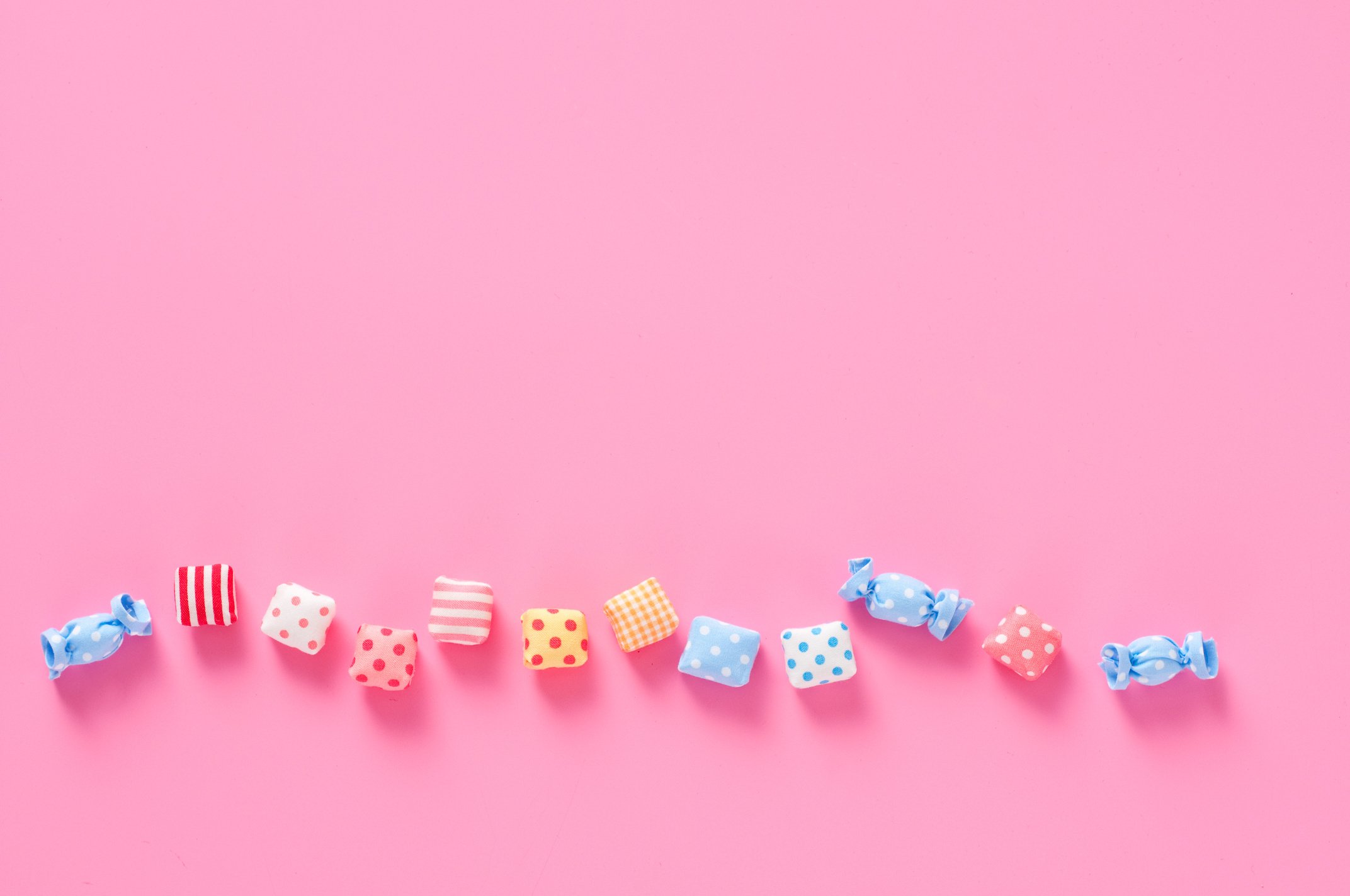 Colourful candy on pink background